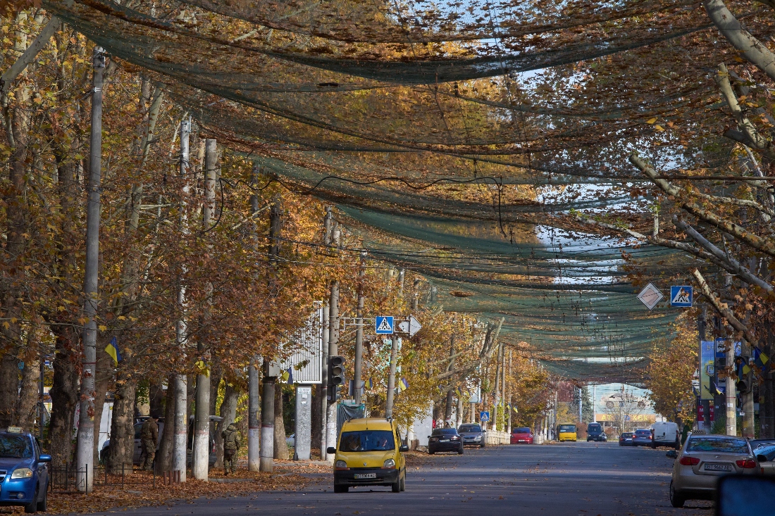 Local residents walk along a street covered with an anti-FPV-drone net in the frontline city of Kherson, Southern Ukraine. (AP)