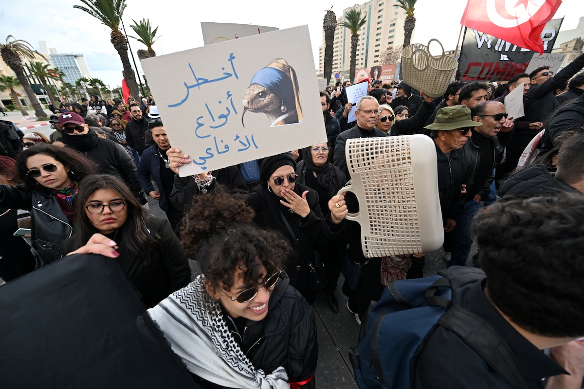Tunisians hold up placards as they demonstrate in a protest dubbed 'March Against Injustice' led by the opposition and the civil society against the Tunisian president's regime, in Tunis on November 22, 2025. (FILE/AFP)