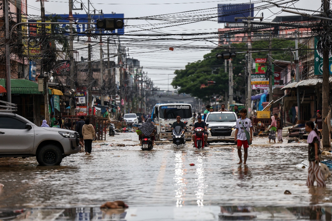 People commute through a flooded area in Hat Yai district, Songkhla province, Thailand. (Reuters)