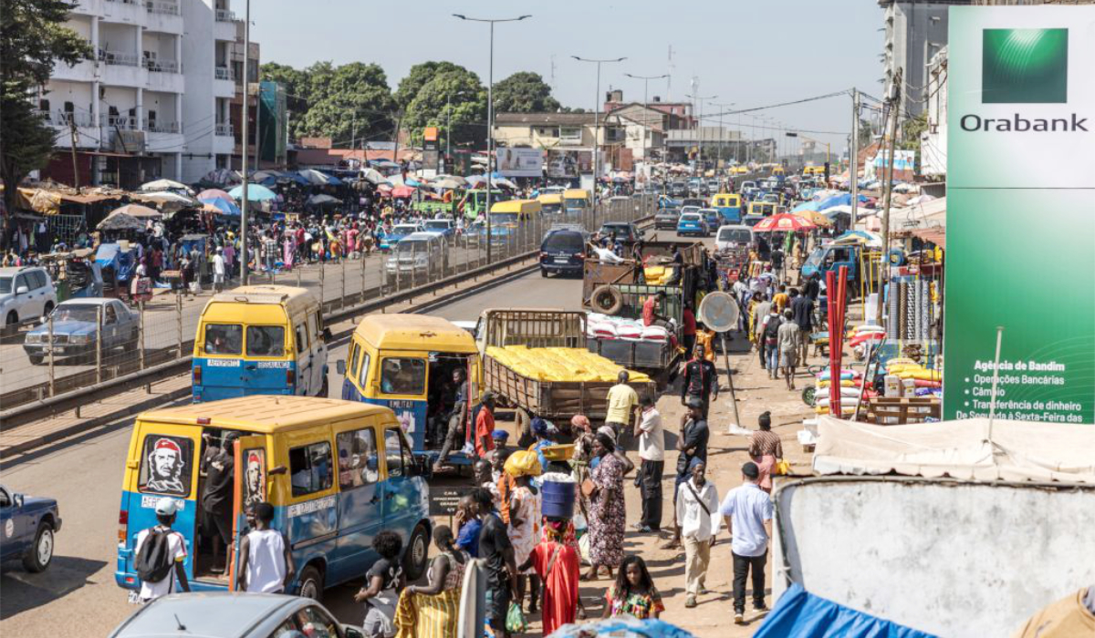 Public transport vehicles pick up passengers at a market in Bissau, on November 28, 2025. (AFP)