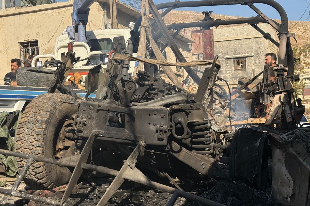A crane removes a burnt Israeli Humvee from a street in the southern Syrian village of Beit Jin on November 28, 2025. (AFP)