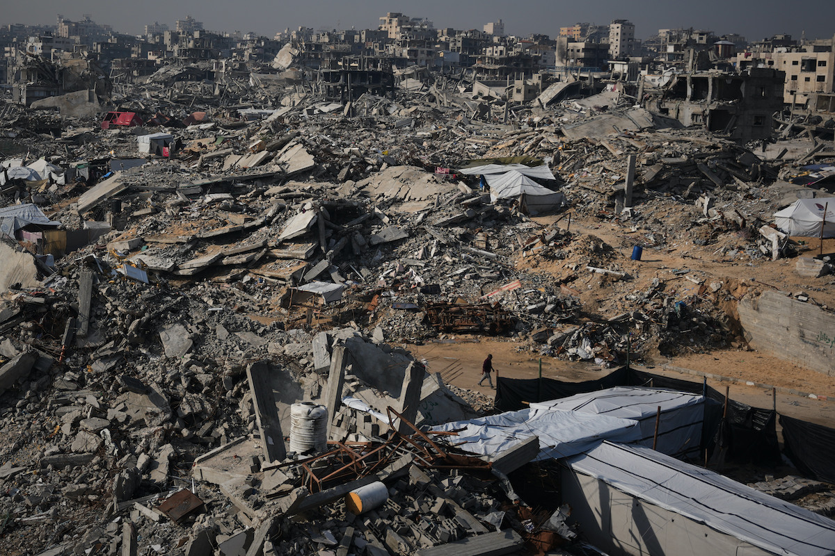 A man walks through the destruction caused by the Israeli air and ground offensive in Sheikh Radwan neighborhood in Gaza City. (AP)