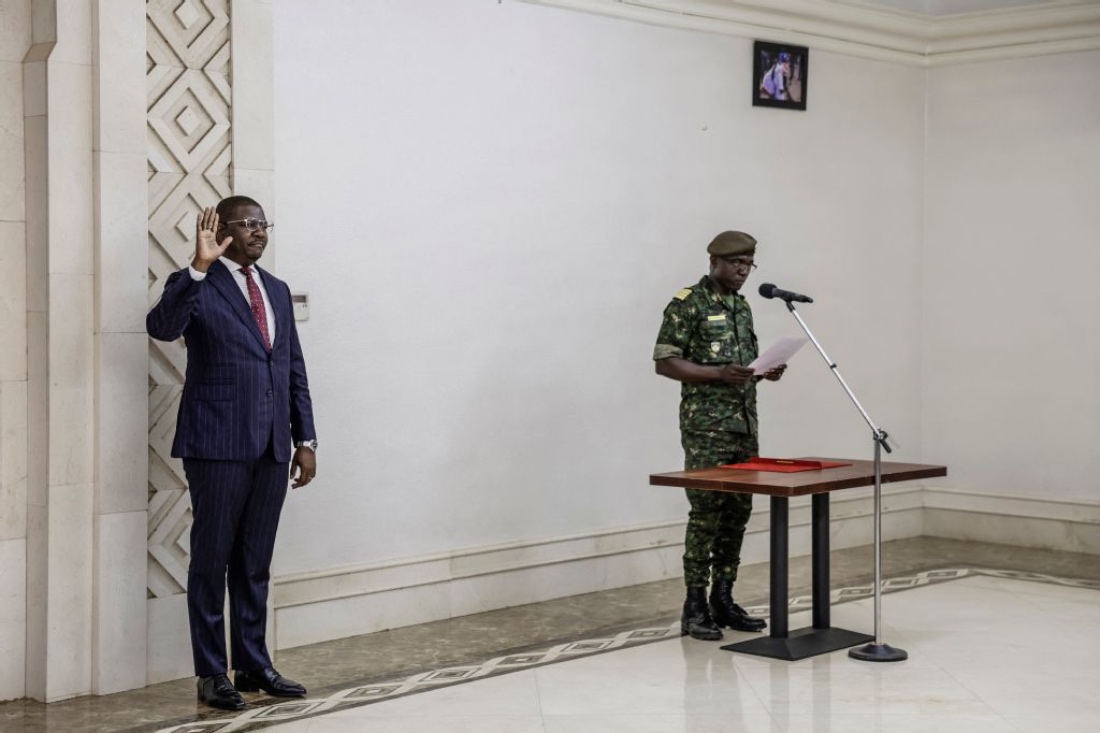 Guinea Bissau newly appointed Prime Minister and Finance Minister of the transitional government Ilidio Vieira Te raises his hand during the swearing in ceremony at the Presidential Palace in Bissau. (AFP)