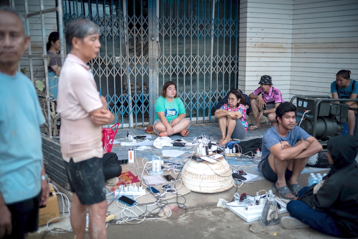 People charge their phones and electronic devices following power outages caused by deadly flooding in Hat Yai district, Songkhla province, Thailand on Nov. 28, 2025. (Reuters)