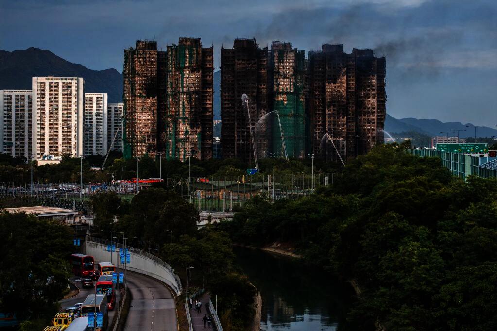 Smoke rises from apartments after a major fire swept through several blocks at the Wang Fuk Court residential estate in Hong Kong's Tai Po district on November 27, 2025. (Photo by Dale DE LA REY / AFP)