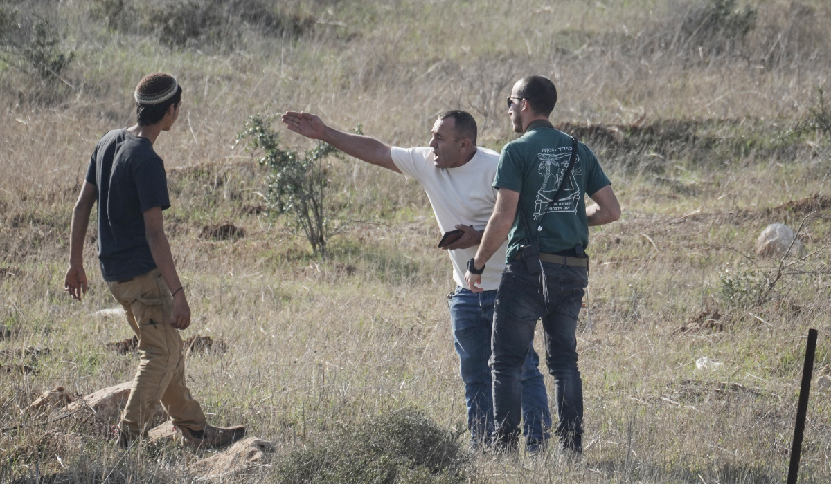 A Palestinian resident of the West Bank village of Tarkumiya argues with Israeli settlers during a protest against what Palestinians say is a land confiscation in the area, Friday, Nov. 28, 2025. (AP)