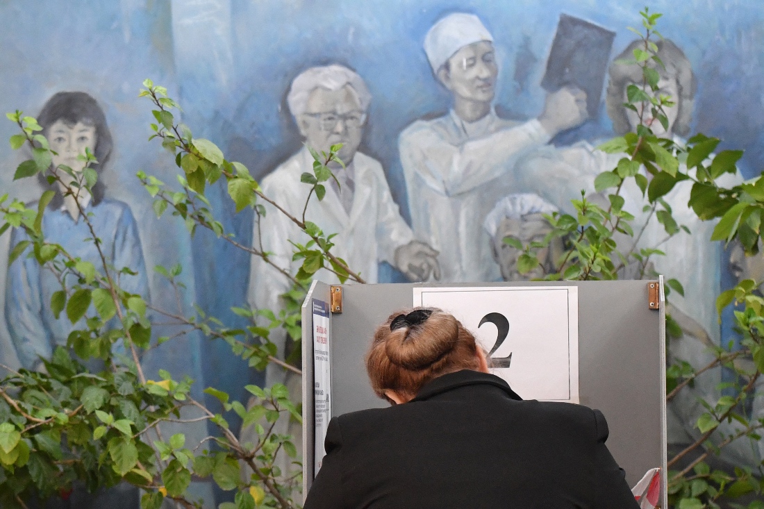 A womam votes at a polling station during Kyrgyzstan's snap parliamentary elections in Bishkek, Kyrgyzstan. (AFP)