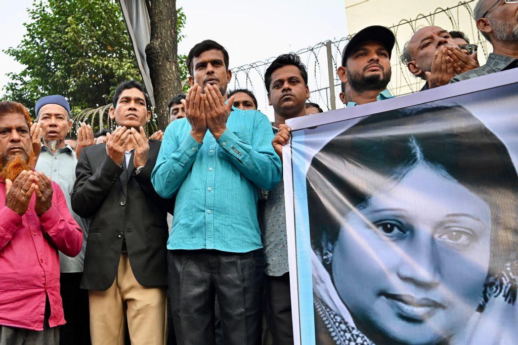 Activists in support of Bangladesh’s former prime minister Khaleda Zia, hold a banner with her portrait as they pray for her recovery in front of the Evercare Hospital in Dhaka on November 29, 2025. (AFP)