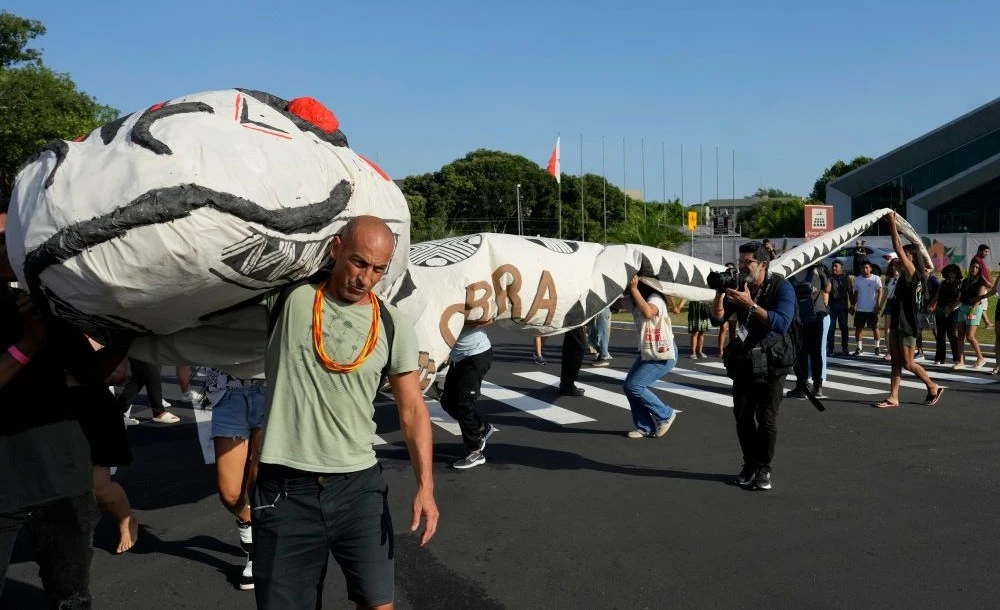 Activists carry a cobra puppet during the COP30 UN Climate Summit, Belem, Brazil, Nov. 6, 2025. (AP Photo)