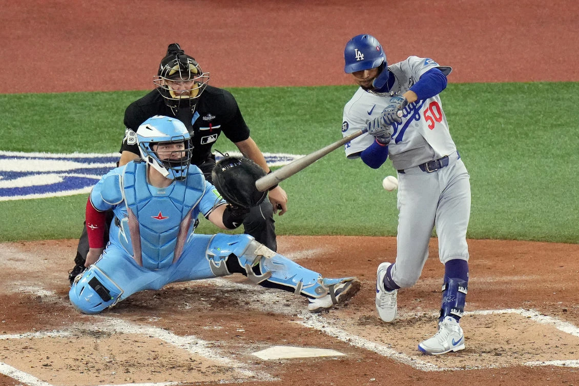 Los Angeles Dodgers’ Mookie Betts hits a two-run single against the Toronto Blue Jays during the third inning in Game 6 of baseball’s World Series in Toronto on Friday, Oct. 31, 2025. (The Canadian Press via AP)