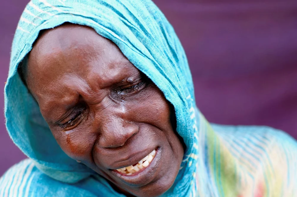 A woman from El-Fasher cries after learning about the killing of her son and brother, in a camp in Al-Dabbah, Sudan, November 3, 2025. (Reuters)