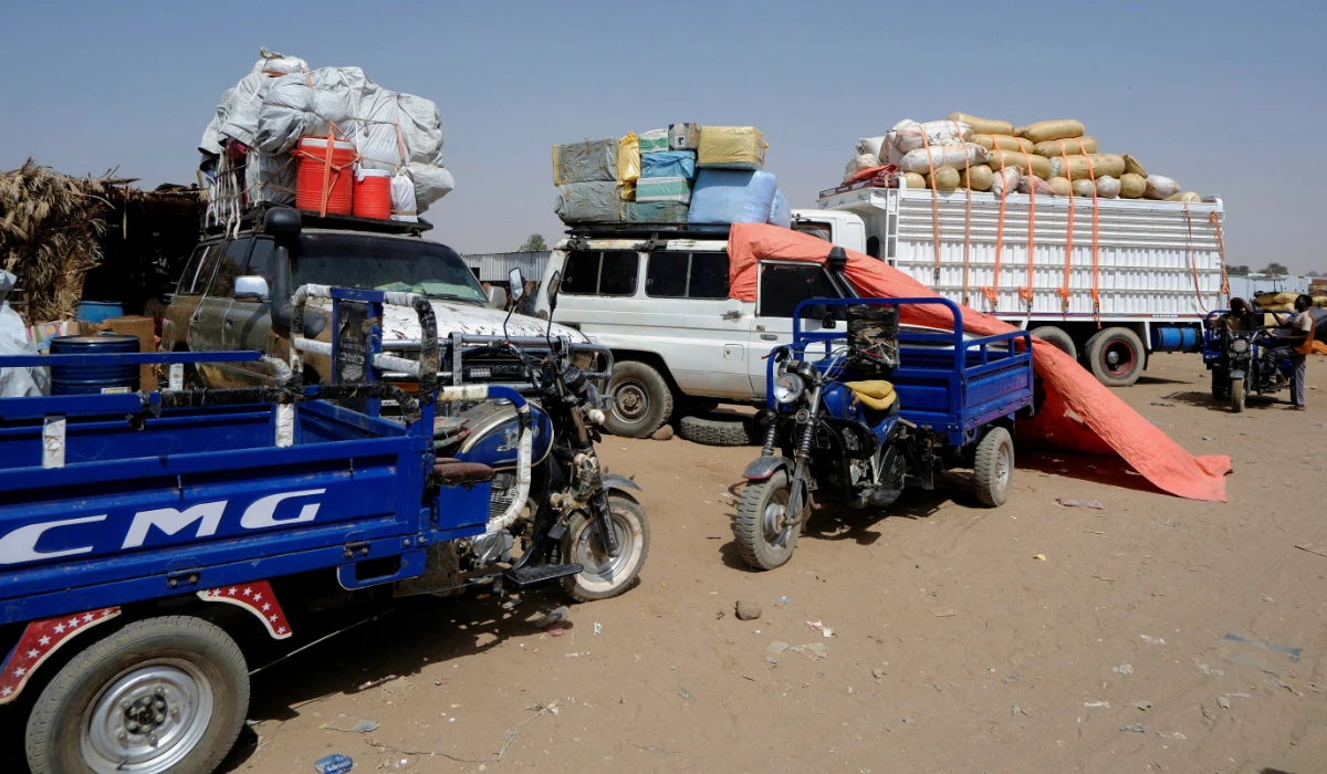 Trucks transport displaced people from El-Fasher. (Reuters)