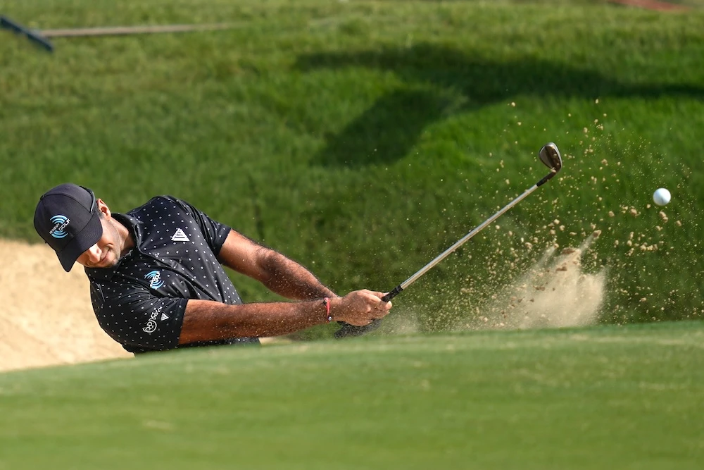 Aaron Rai of England hits a shot from a bunker on the 7th hole during the third round of the Abu Dhabi Golf Championship in Abu Dhabi Saturday. (AP)
