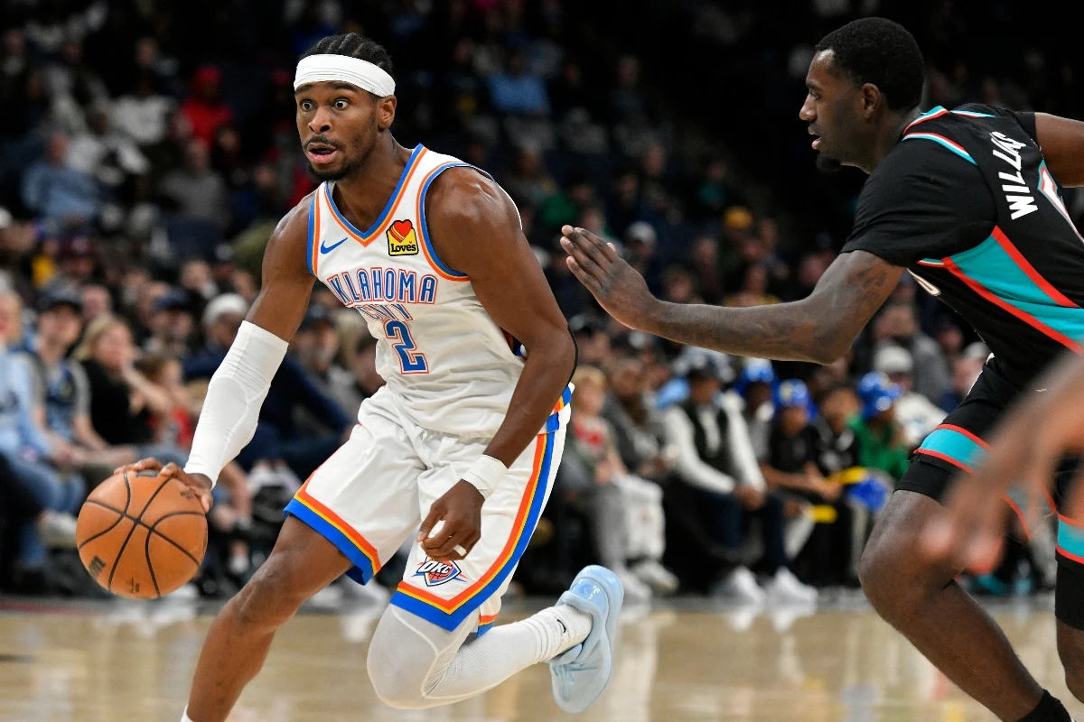 Oklahoma City Thunder guard Shai Gilgeous-Alexander (2) handles the ball ahead of Memphis Grizzlies guard Vince Williams Jr., right, in the second half of an NBA game Sunday in Memphis, Tenn. (AP)