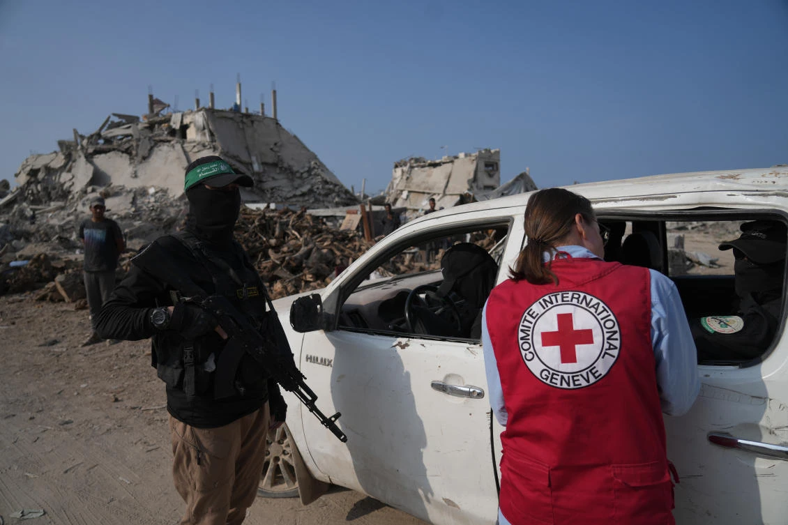 Hamas militants accompanied by members of the International Committee of the Red Cross (ICRC) head to east of Gaza City to search for the bodies of hostages, Thursday, Nov. 13, 2025. (AP)