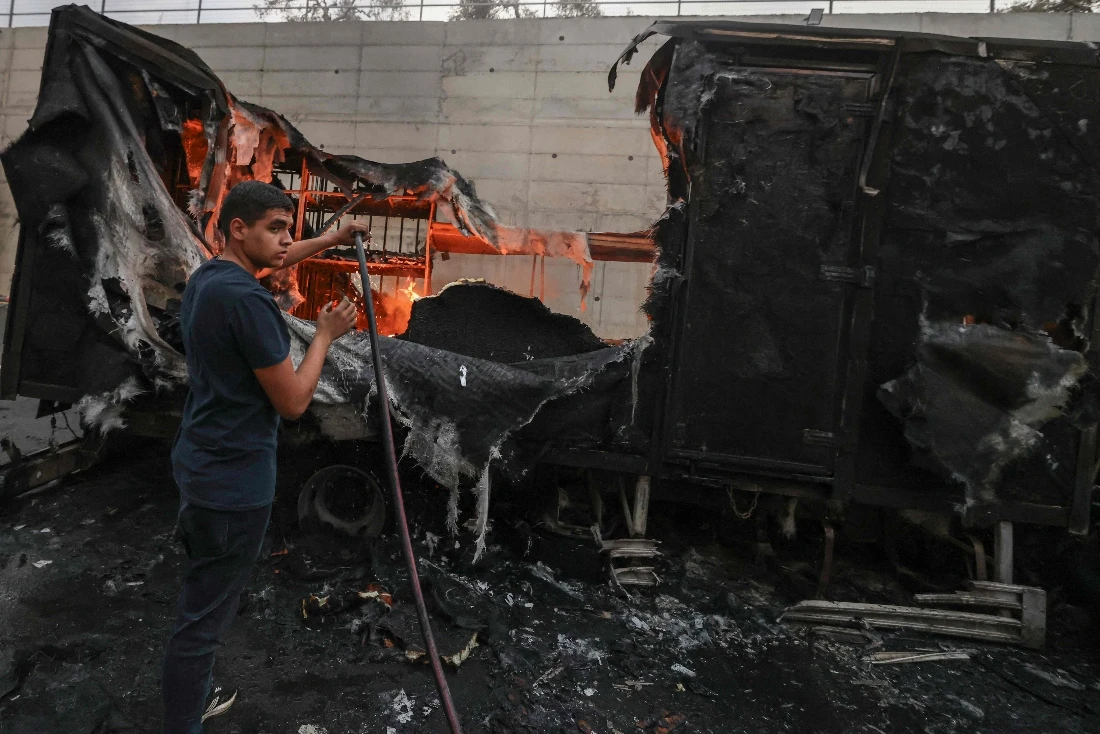A Palestinian man tries to extinguish flames from a burning truck after an Israeli settlers attack in the village of Beit Lid, east of Tulkarm in the occupied West Bank. (AFP)