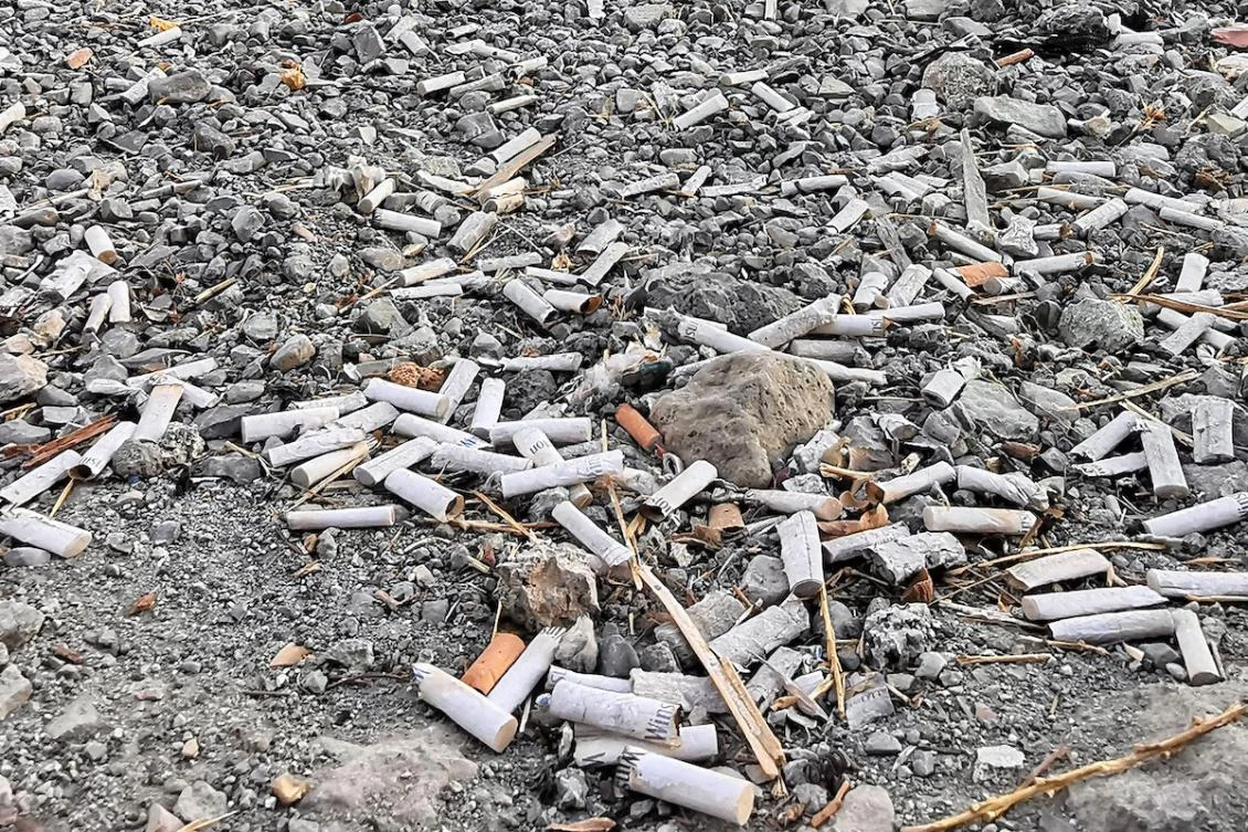 Discarded cigarette filters are pictured on the ground at Pardisan park in Tehran on September 13, 2025. (FILE/AFP)