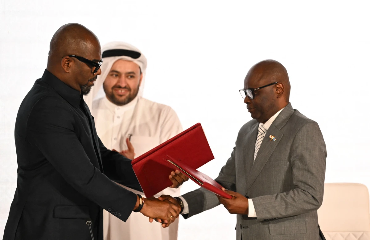 Qatar’s chief negotiator Mohammed Al-Khulaifi (C) observes as Sumbu Sita Mambu (L), a high representative of the head of state in the Democratic Republic of Congo (DRC) and and Rwanda-backed armed group M23 executive secretary Benjamin Mbonimpa (R) as they shake hands during the signing ceremony of the Comprehensive Peace Agreement. (AFP)