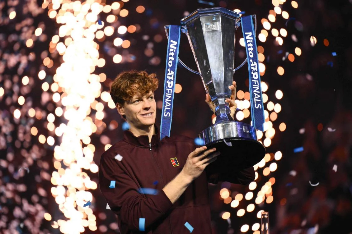 Italy’s Jannik Sinner lifts the trophy after winning over Spain’s Carlos Alcaraz at the end of the men’s single final match at the ATP Finals tennis tournament, in Turin, on November 16, 2025. (AFP)
