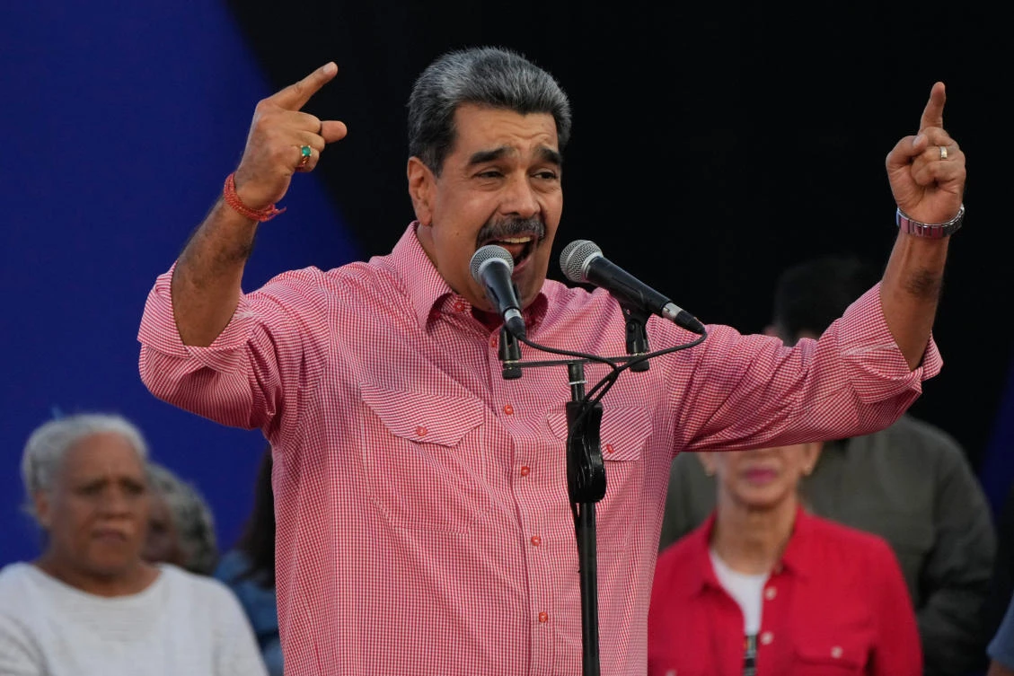 Venezuelan President Nicolas Maduro addresses civilians taking an oath to join a state-organized defense network in the Petare neighborhood of Caracas, Venezuela, Nov. 15, 2025. (AP Photo)
