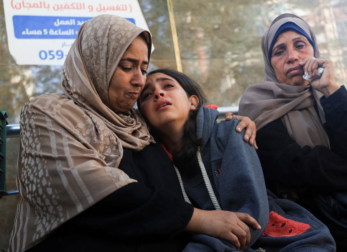 Mourners react as they attend the funeral of Palestinians who were killed in overnight Israeli strikes, at Al-Shifa Hospital in Gaza City, November 20, 2025. (Reuters)