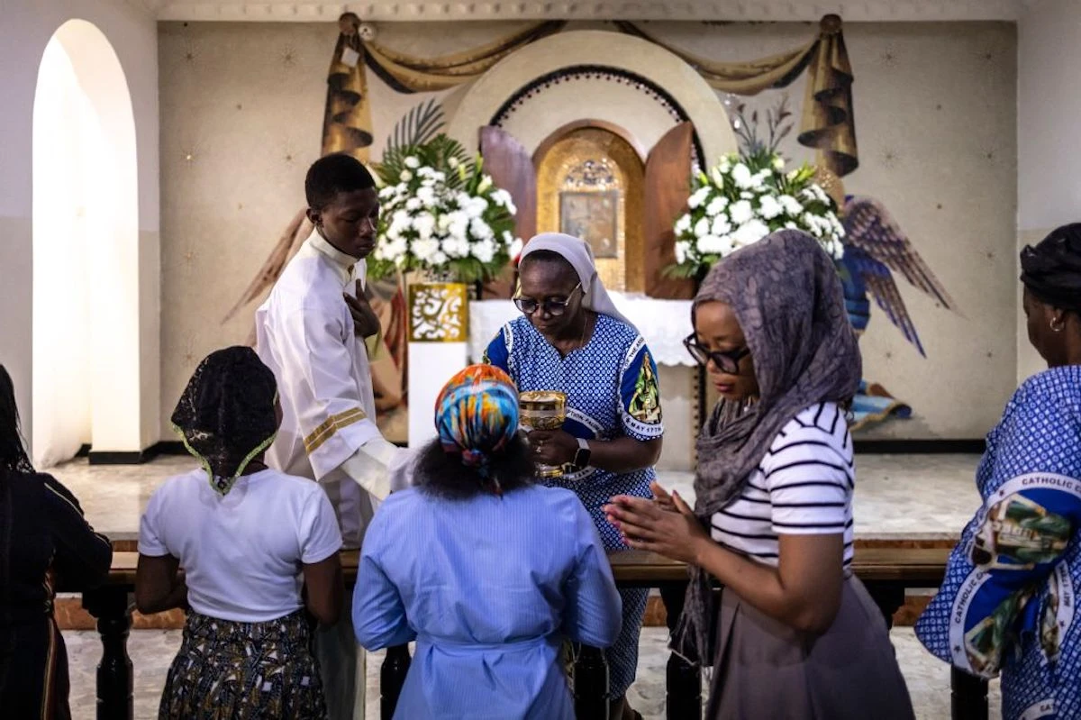 Catholics attending a mass at the Church of the Assumption in Lagos. Dozens of pupils have been abducted from a Catholic school in a Western region of Nigeria in the second such incident in less than a week. (AFP/File)