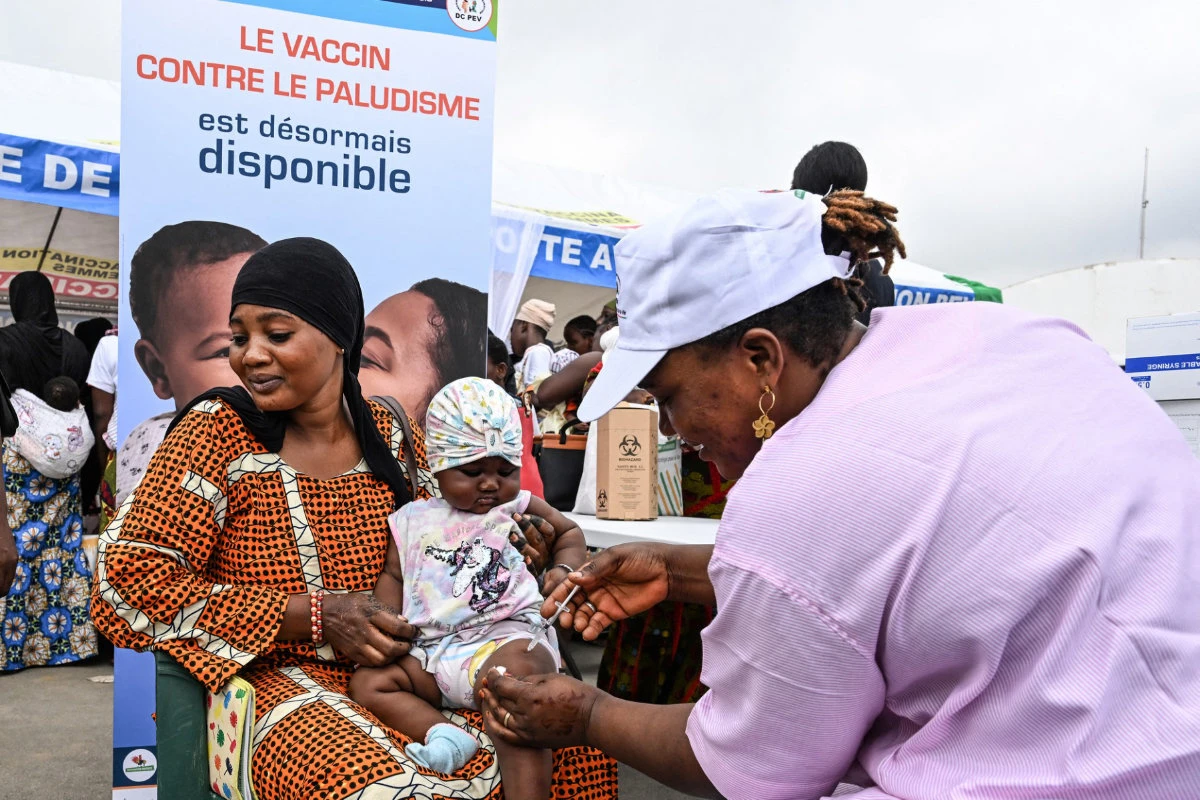 A health worker vaccinates a baby against malaria during the launch of the vaccination campaign for children from zero to 23 months at La Marie d'Abobo, a popular commune in Abidjan on July 15, 2024. (AFP)