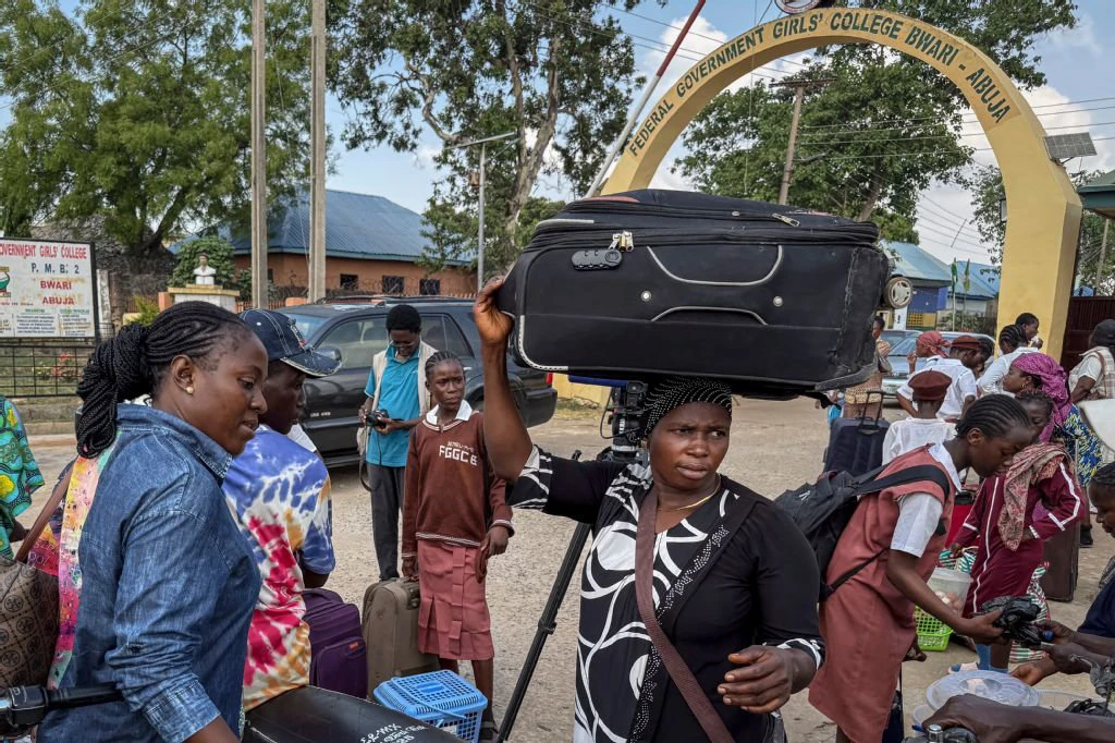 Relatives and students leave the Federal Government Girls College in Bwari, on the outskirts of Abuja, on November 22, 2025. The national education ministry ordered 47 boarding secondary schools across the country be shut following after gunmen kidnapped more than 300 students and teachers from a Catholic school. (AFP)