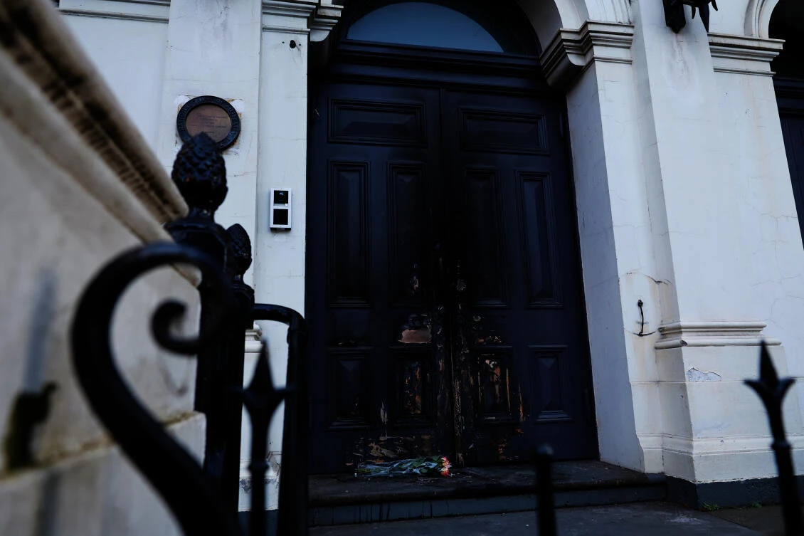 Flowers are left at the fire-damaged door of the East Melbourne Synagogue in Melbourne, Australia, July 7, 2025, following an arson attack. (AP)