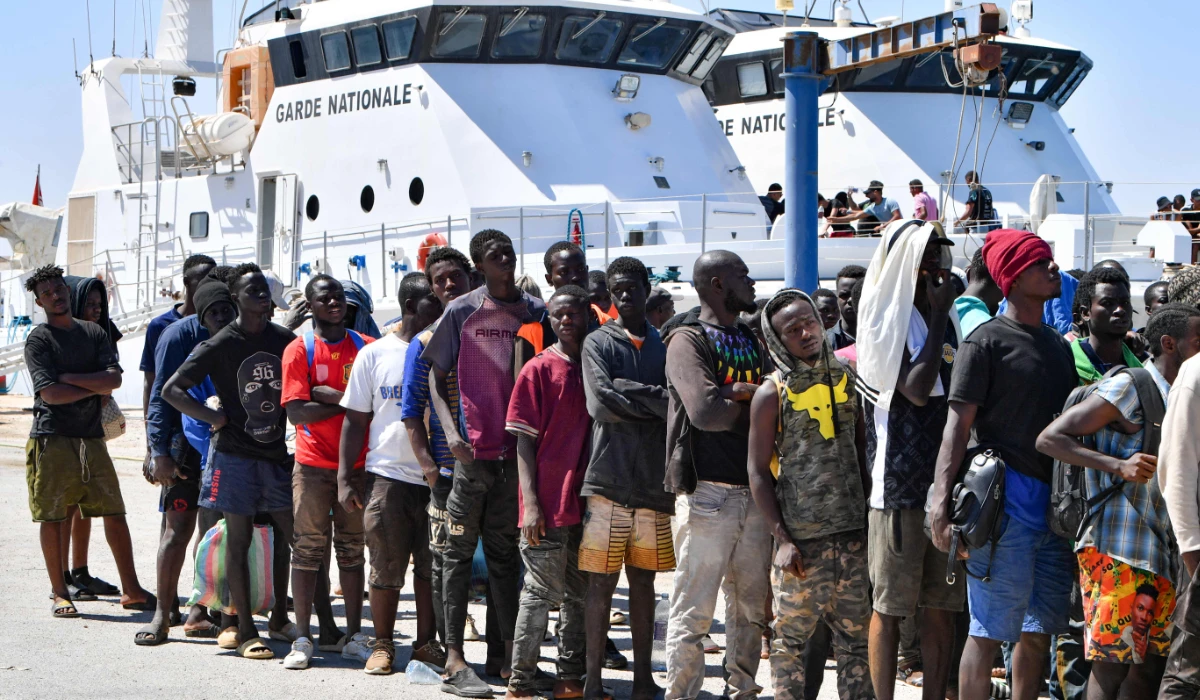 Migrants of African origin trying to flee to Europe, disembark in Sfax from a ship owned by the Tunisian coast guards, after being intercepted by them at sea on August 10, 2023. (AFP)