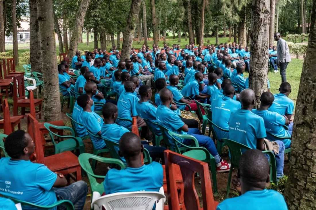 Cyprien Mudeyi, manager of the demobilization center for the Rwanda Demobilization and Reintegration Commission, speaks with former soldiers of Rwandan origin who previously fought in armed groups in eastern Democratic Republic of Congo during a counseling and experience-sharing session at the Mutobo Demobilization and Reintegration Resource Center in Ruhengeri. (AFP)