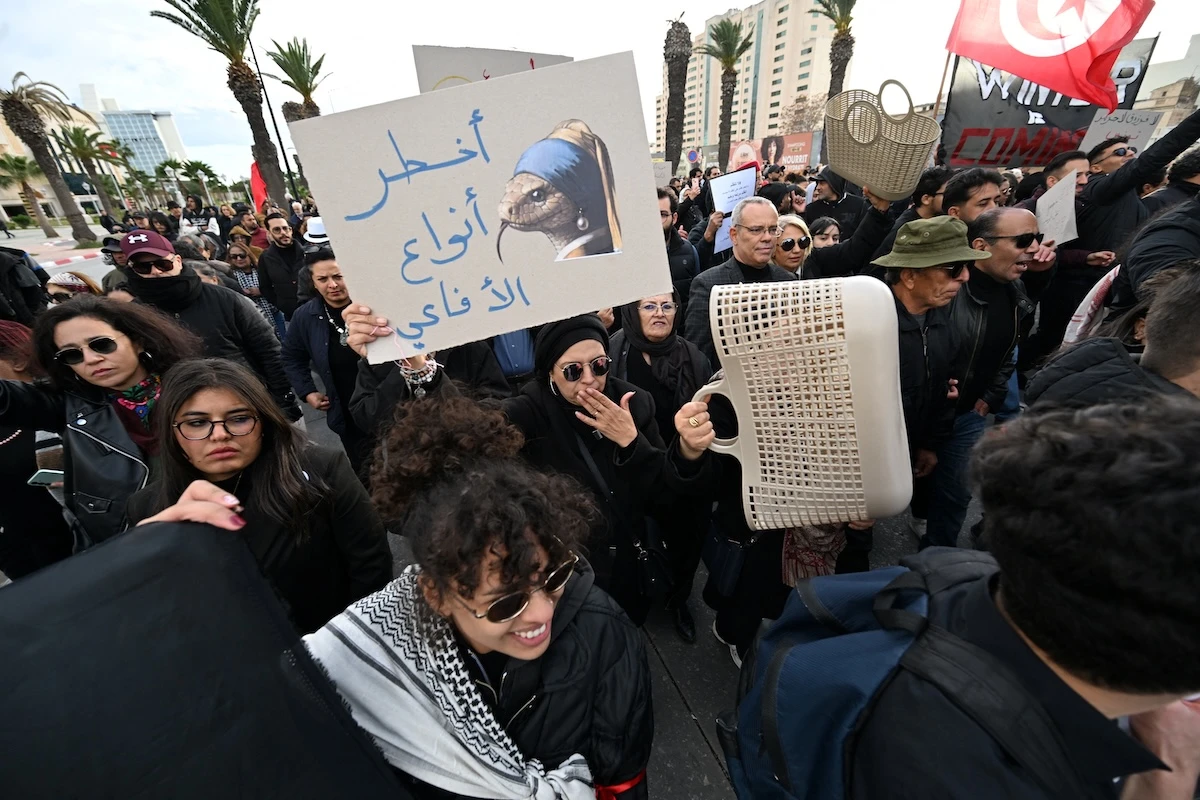 Tunisians hold up placards as they demonstrate in a protest dubbed 'March Against Injustice' led by the opposition and the civil society against the Tunisian president's regime, in Tunis on November 22, 2025. (FILE/AFP)
