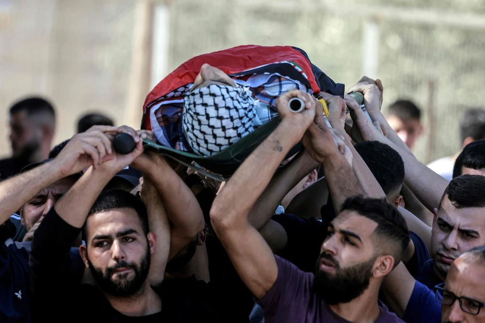 Mourners carry the body of Yamen Hamed during his funeral in West Bank on Oct. 31, 2025. (AFP)