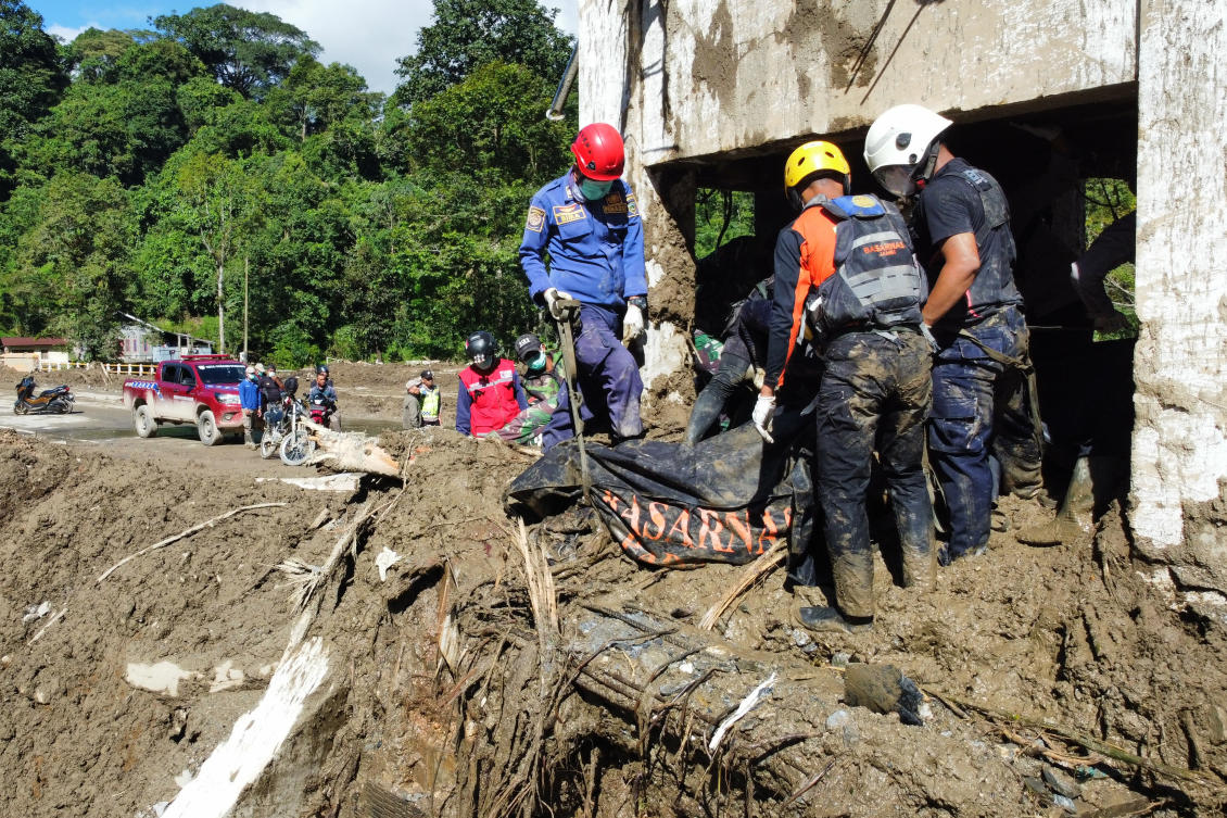 Rescuers recover the body of a flood victim in Padang Panjang, West Sumatra, Indonesia on Dec. 1, 2025. Flooding displaced 290,700 people in North Sumatra, West Sumatra and Aceh provinces. (AP)