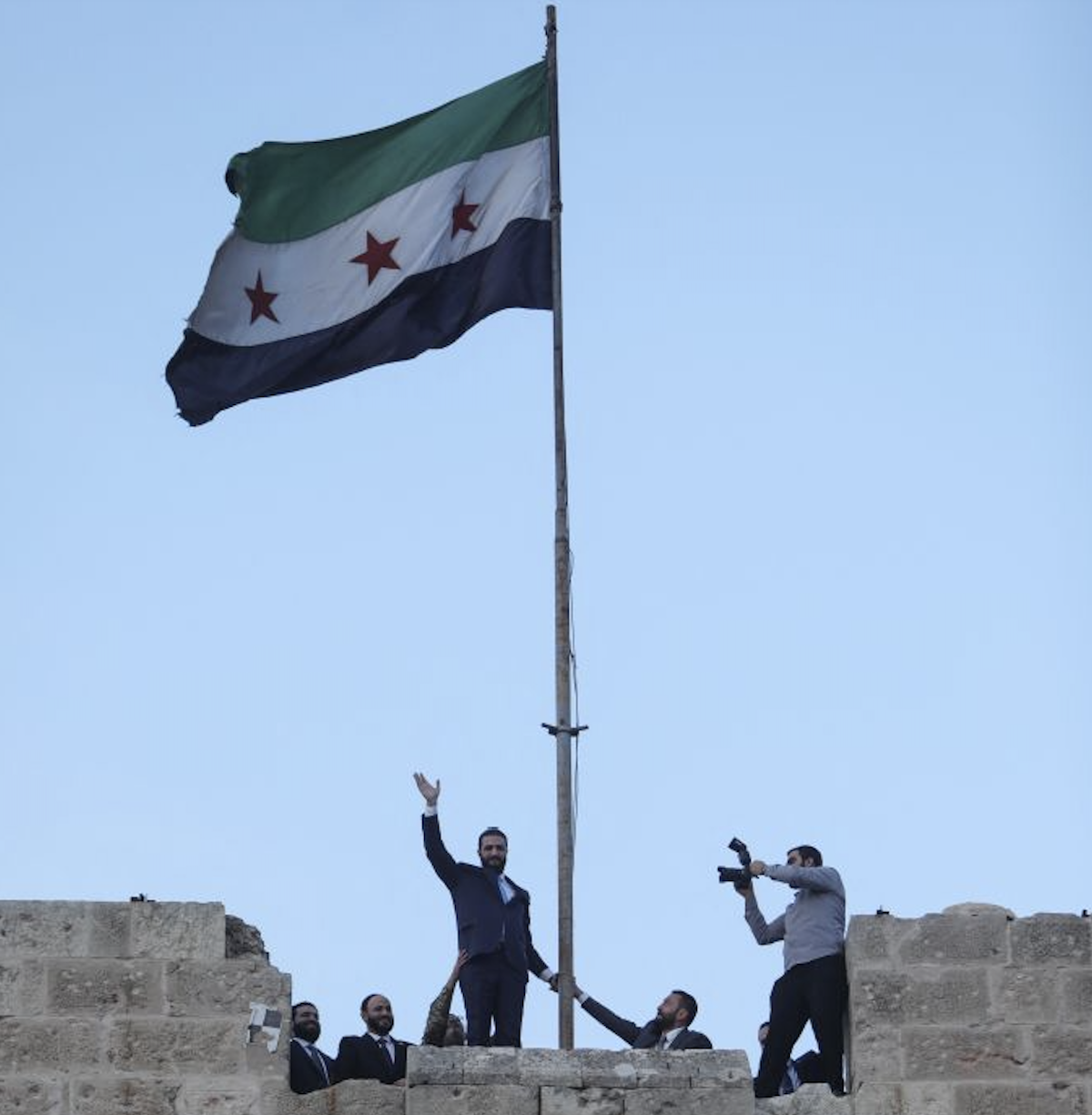 Syrian President Ahmad Al-Sharaa waves to the crowd at the gate of Aleppo’s Citadel during celebrations marking one year since his coalition entered the northern city and swiftly took control of it, on November 29, 2025. (AFP)