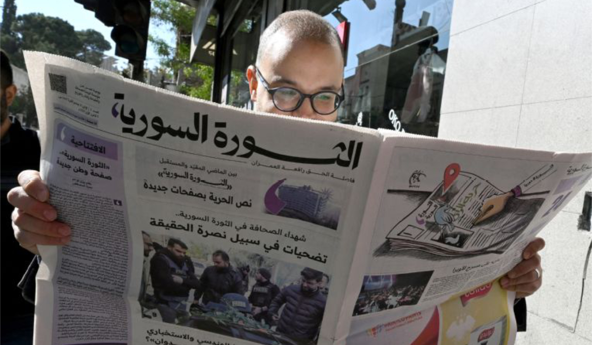 A man reads the newspaper in Damascus on Monday. (AFP)