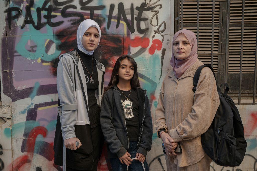 From left: Sisters Raghad Al-Fara, Argwan and their mother Shadia now live in a shelter for refugee women in Athens after being evacuated from Palestine. (AFP)