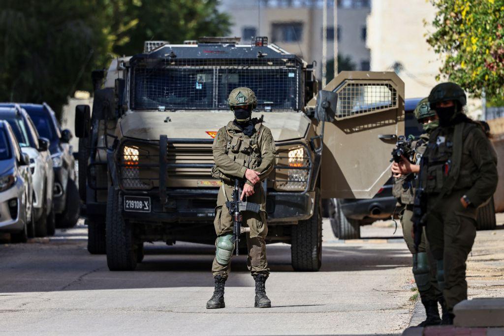 Above, Israeli soldiers take positions during a raid in Ramallah in the occupied West Bank on Dec. 1, 2025. The Israeli army has stepped up its activities in the West Bank. (AFP)