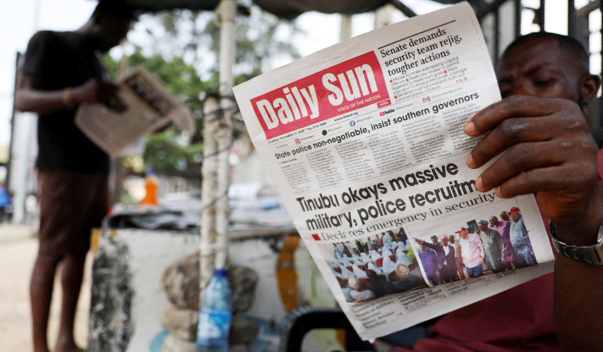 People read newspapers at a roadside newspaper stand in Ikoyi Lagos, Nigeria, November 27, 2025. (REUTERS)