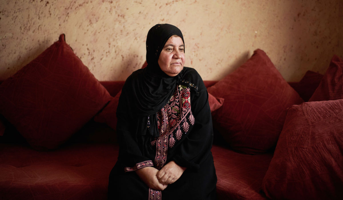 Palestinian Afaf Abu Alia, 55, who was attacked by Israeli settlers while harvesting olives in Turmus Ayya last October, poses for a photo in her home in the West Bank village of al-Mughayyir, Wednesday, Nov. 12, 2025. (AP)