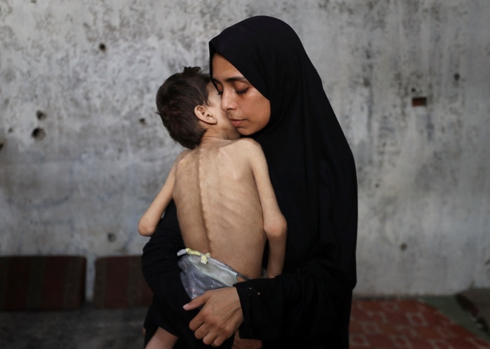 Displaced Palestinian mother her son, who suffers from cerebral palsy, at a school shelter in Gaza City. (Reuters)