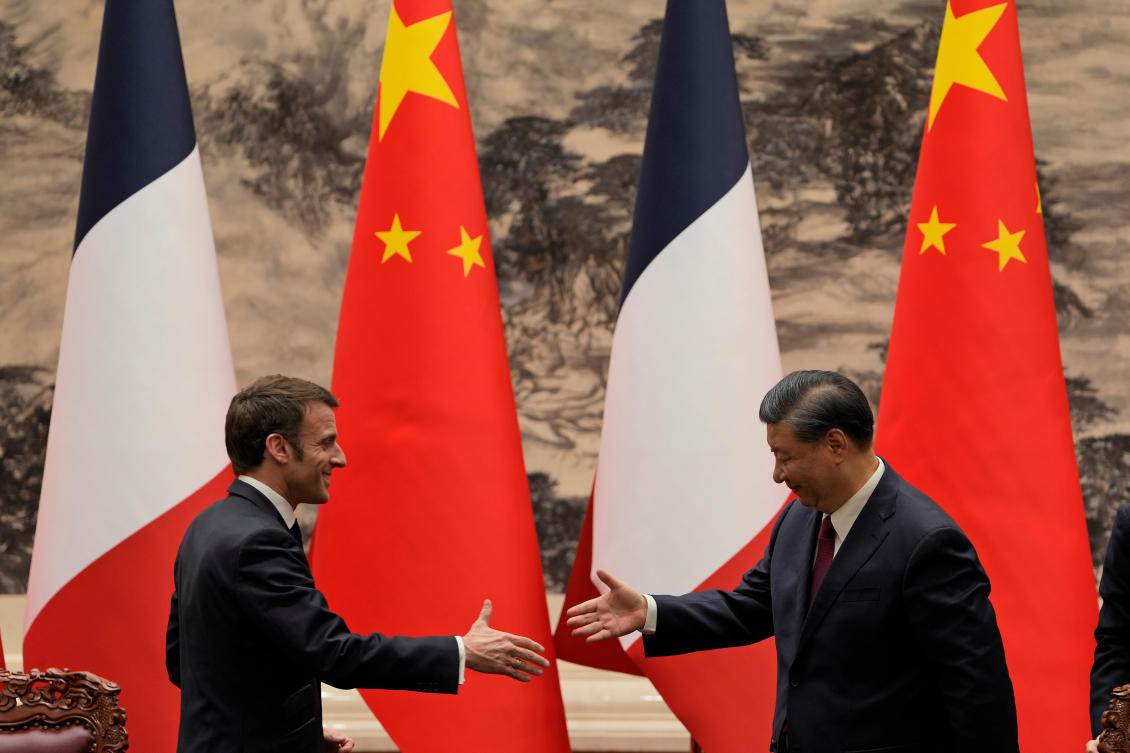 French President Emmanuel Macron, left, shakes hands with Chinese President Xi Jinping after meeting the press at the Great Hall of the People in Beijing on April 6, 2023. (AP)