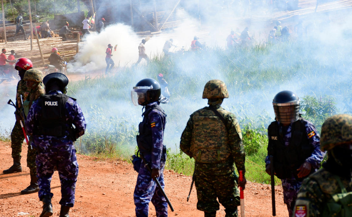 Supporters of Ugandan presidential candidate Robert Kyagulanyi run as riot police fire tear gas canisters to disperse the crowd during a campaign event in Kira Municipality, Wakiso District, on the outskirts of Kampala on Dec. 1, 2025. (Reuters)