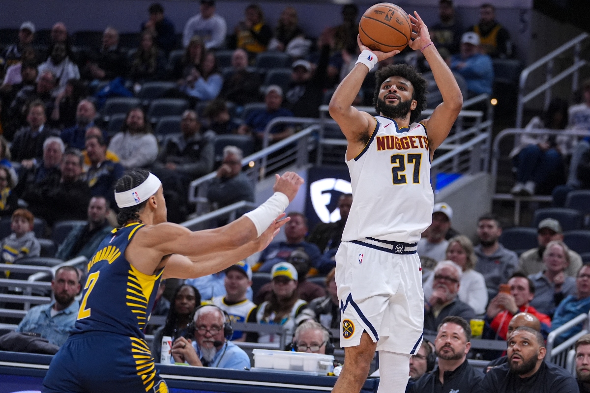 Denver Nuggets guard Jamal Murray hits a three-point basket over Indiana Pacers guard Andrew Nembhard for his 50th point during the second half of an NBA basketball game in Indianapolis Wednesday. (AP Photo/Michael Conroy)