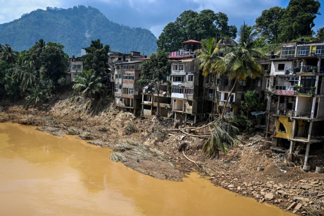 Uprooted trees lie along damaged buildings following a landslide in the aftermath of Cyclone Ditwah in Gampola town, in Kandy district, Sri Lanka. (AFP)