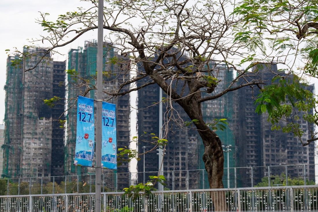 Banners promoting the Hong Kong Legislative Council General Election hang near the site of the fire at Wang Fuk Court in the Tai Po district of Hong Kong. (AP)