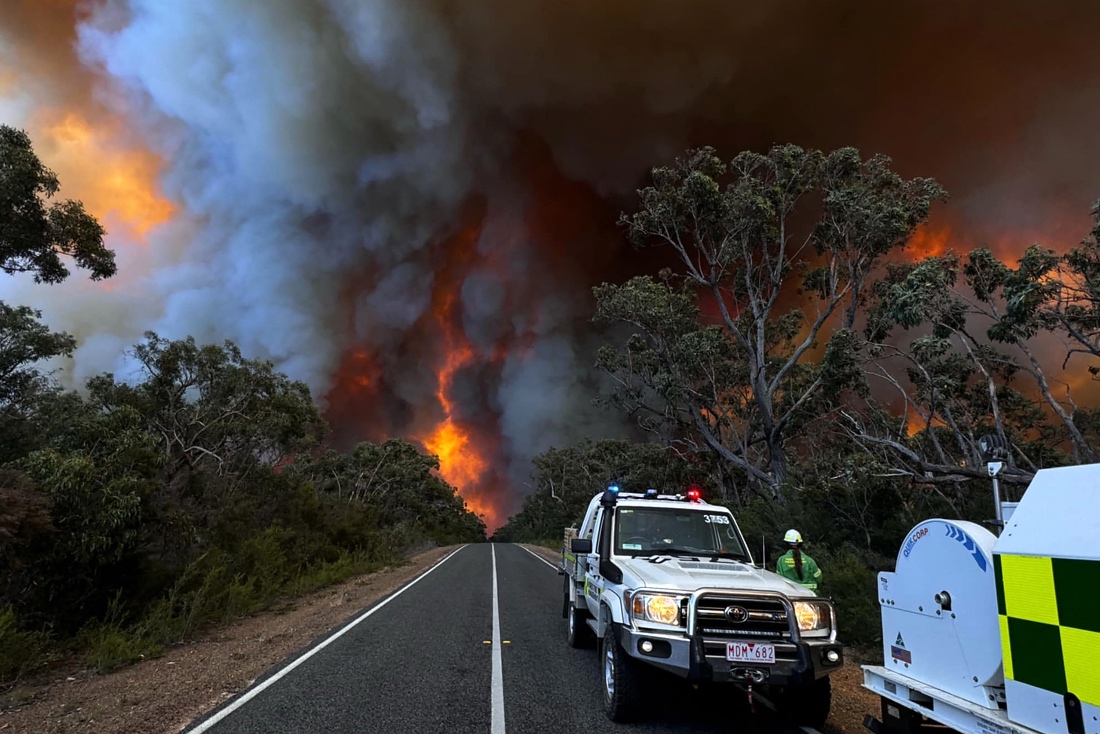 A photo shows officials on a road near a bushfire in the Grampians National Park in Australia's Victoria state. (AFP)