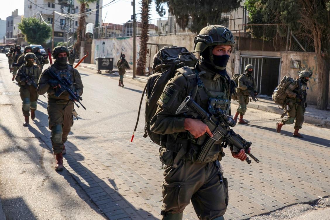 Israeli soldiers walk during a military operation in the town of Qalqiya, in the occupied West Bank on December 4, 2025. (AFP)