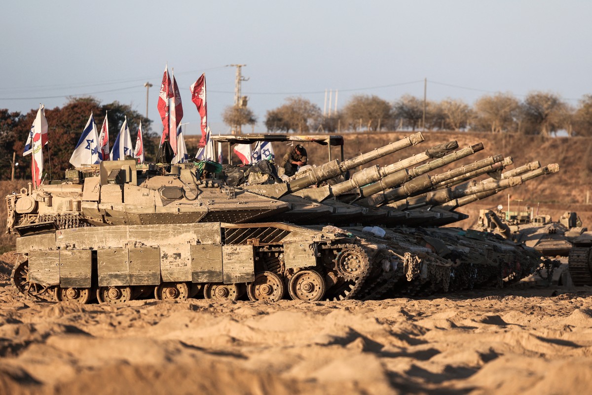 An Israeli soldier sits on top of a tank at a position in the south, near the Israel–Gaza border fence, Oct. 30, 2025. (AFP)