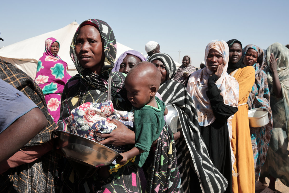 Women displaced from El-Fasher stand in line to receive food aid at the newly established El-Afadh camp in Al Dabbah, in Sudan's Northern State, on Nov. 16, 2025. (AP File Photo)